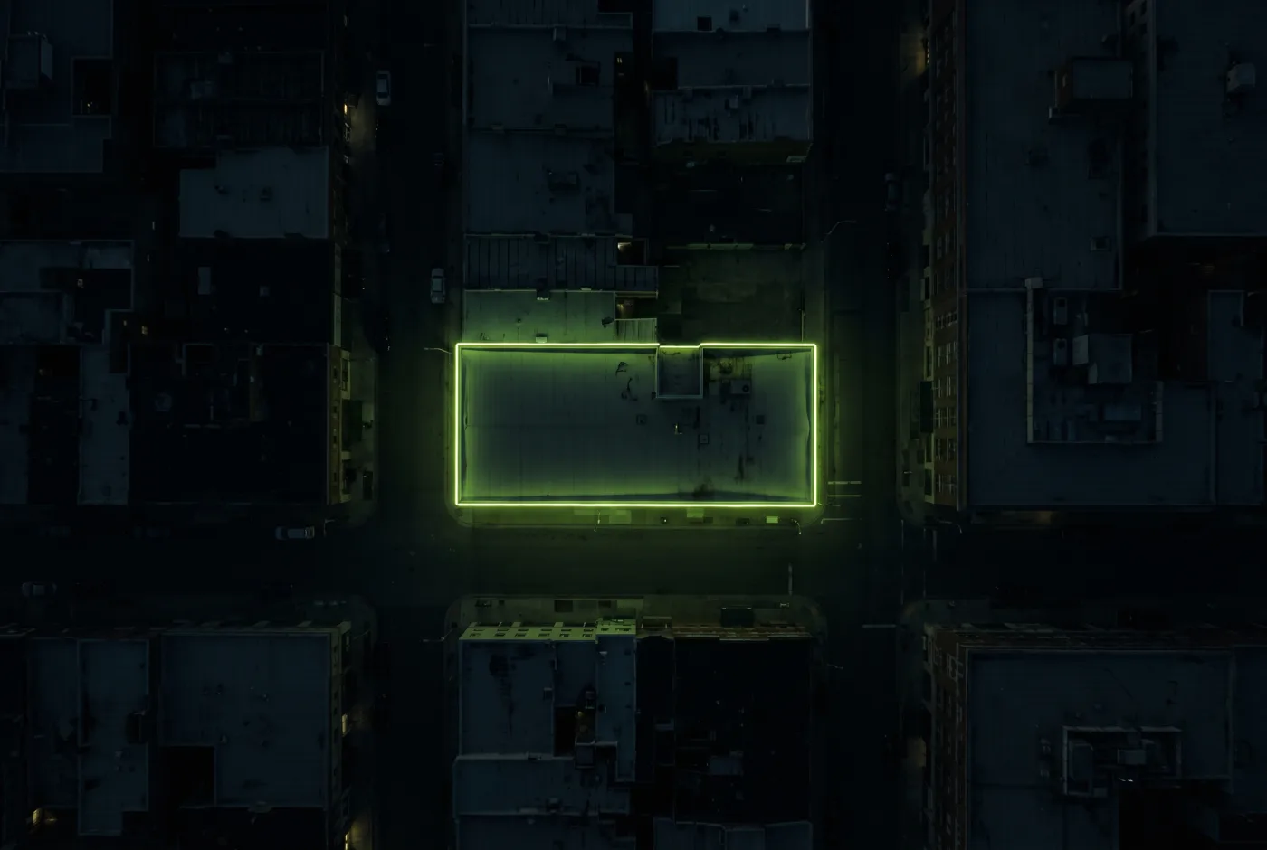 Aerial night view of one building outlined in glowing light