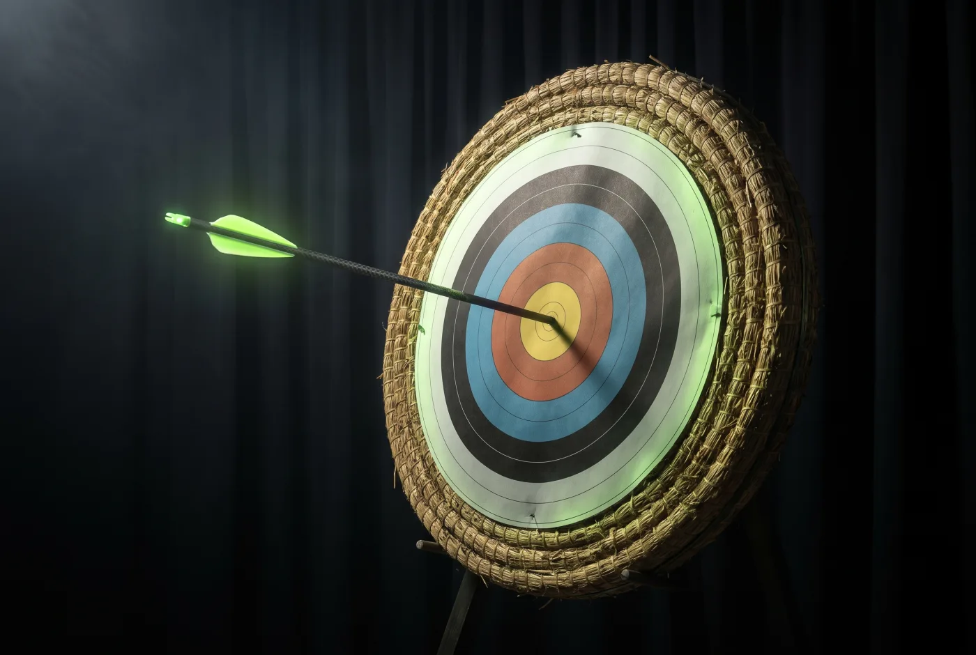 An arrow striking the center of an archery target